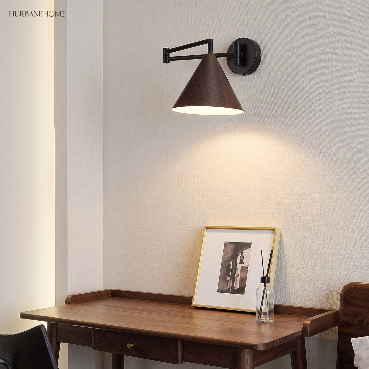 Cone shade swing arm wall sconce above a desk