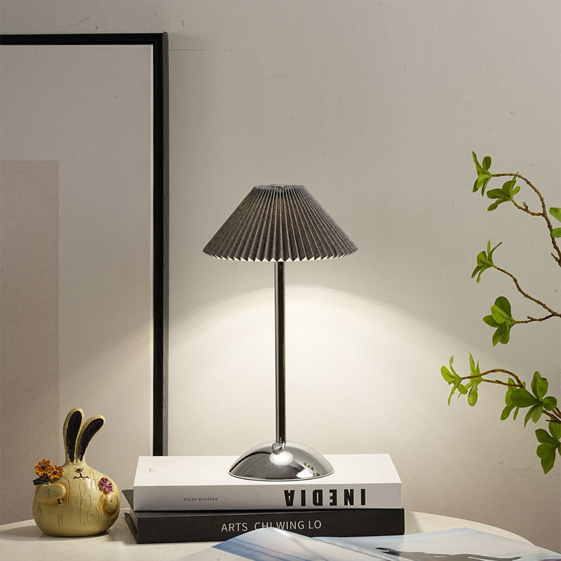 Close view of the crisp pleated fabric shade folds on the table lamp