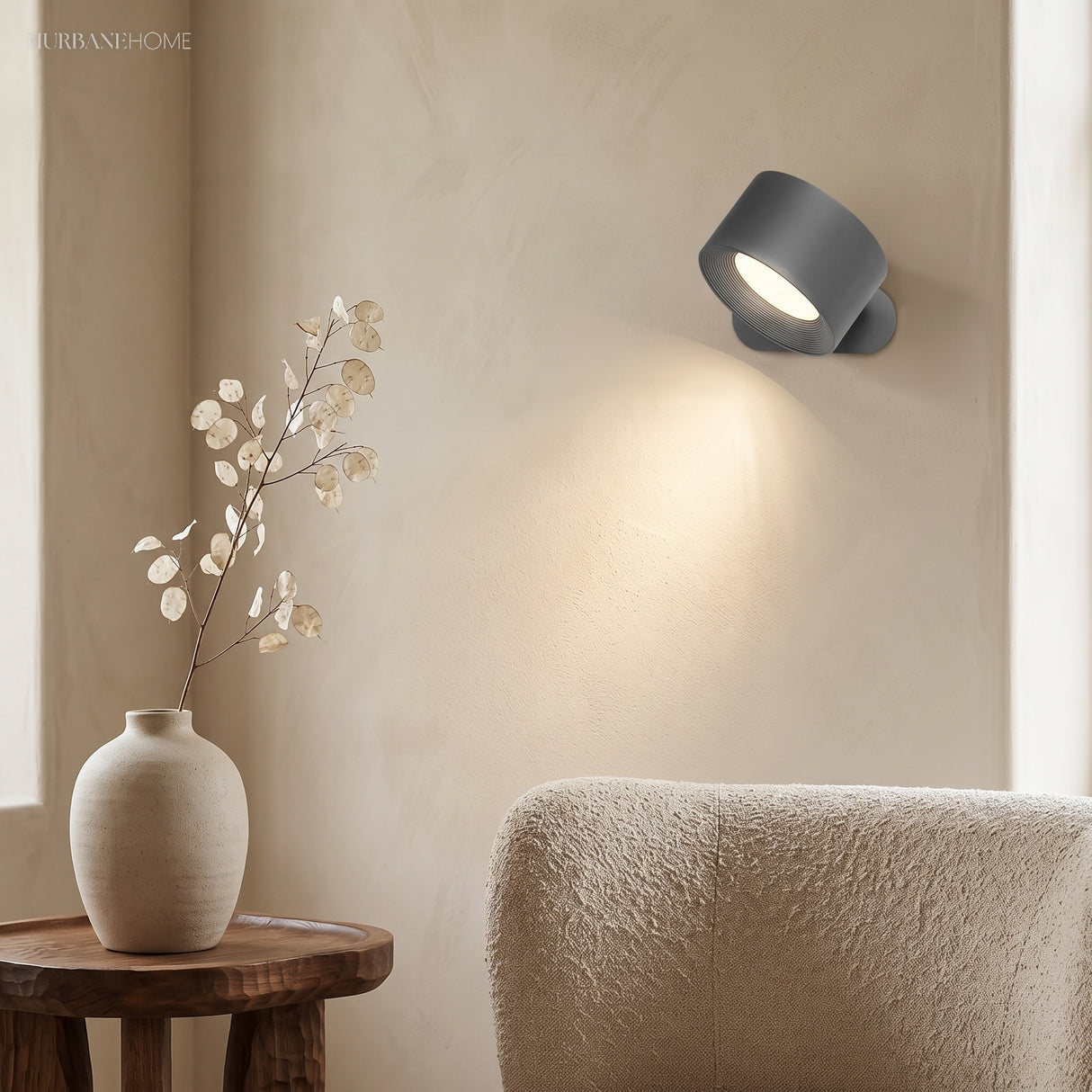 Black cordless wall light glowing in a warm living room corner