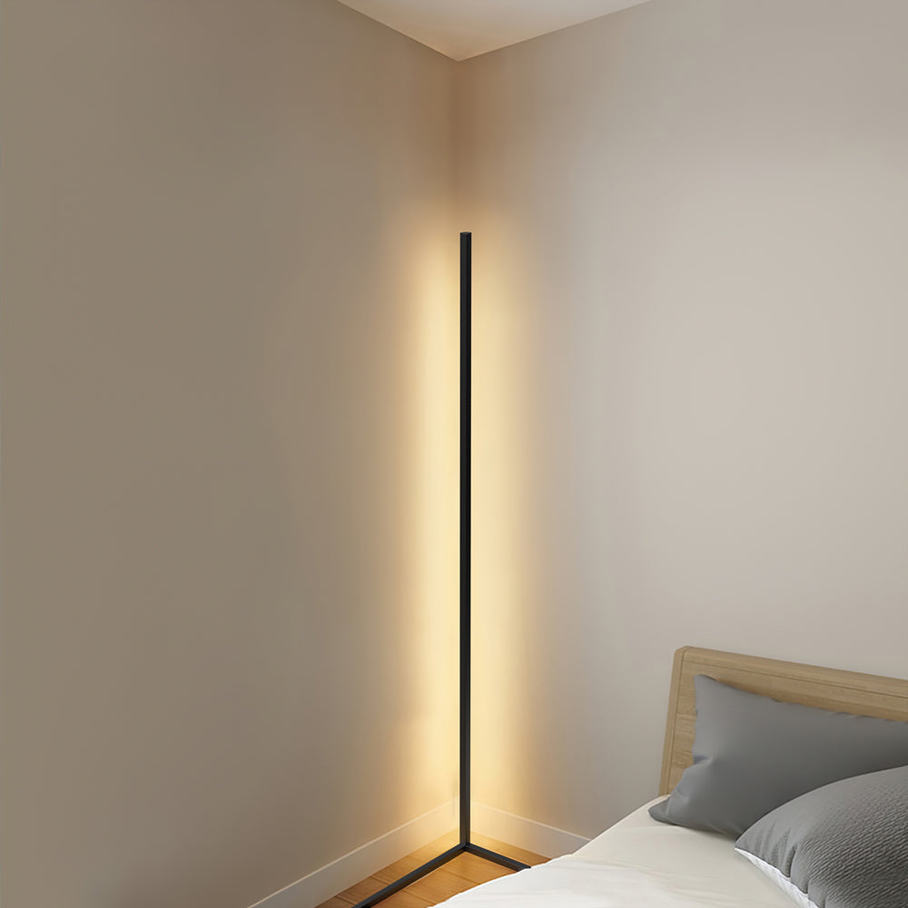Slim corner floor lamp lighting a modern living room with warm ambient glow