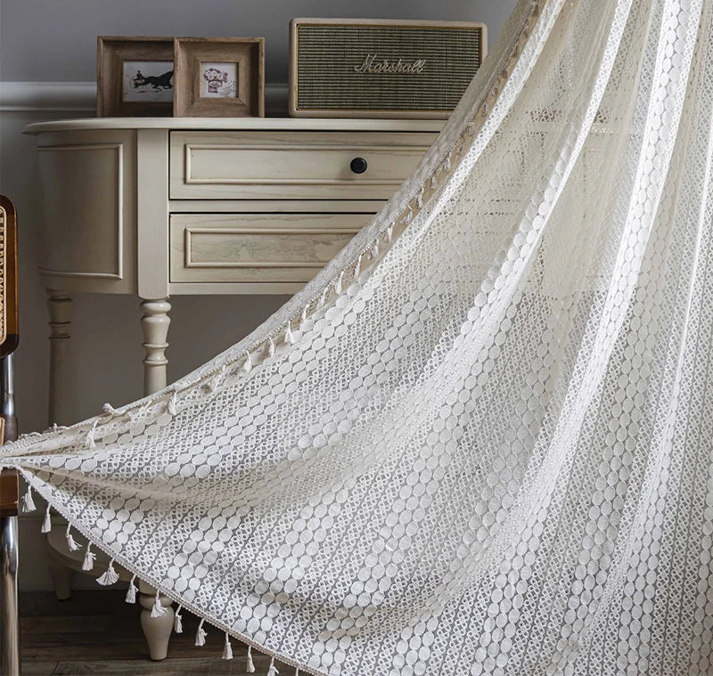 Cotton crochet lace curtains filtering daylight in cozy reading nook