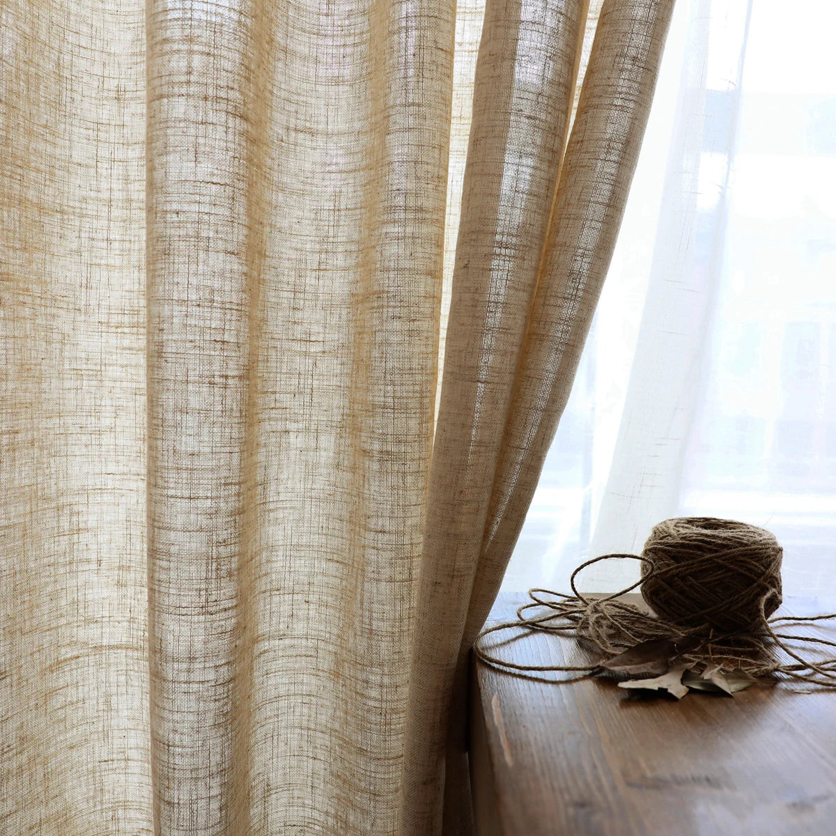 Cotton linen window panels draped softly over bedroom window