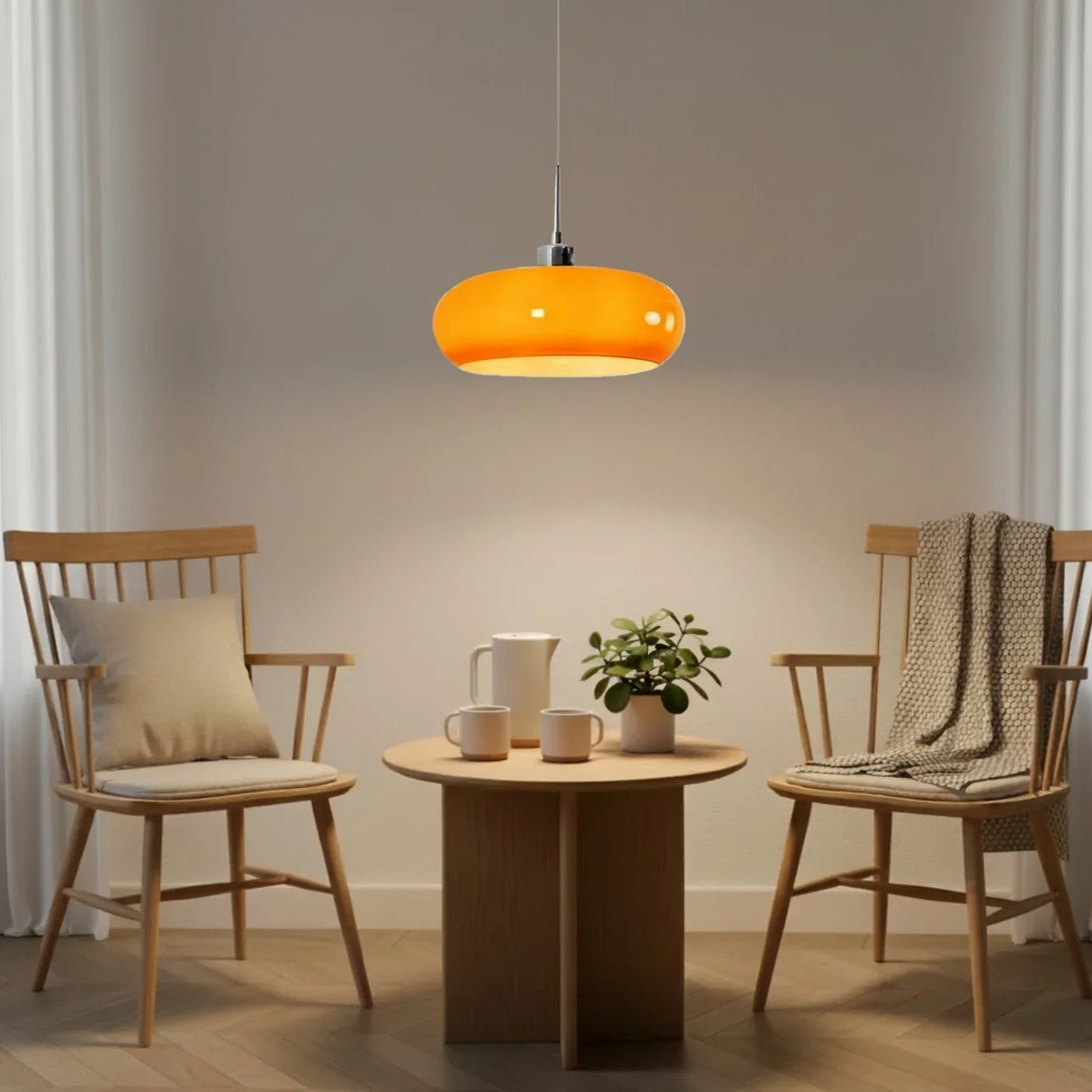 Two cream glass pendant lights above a long wooden dining table