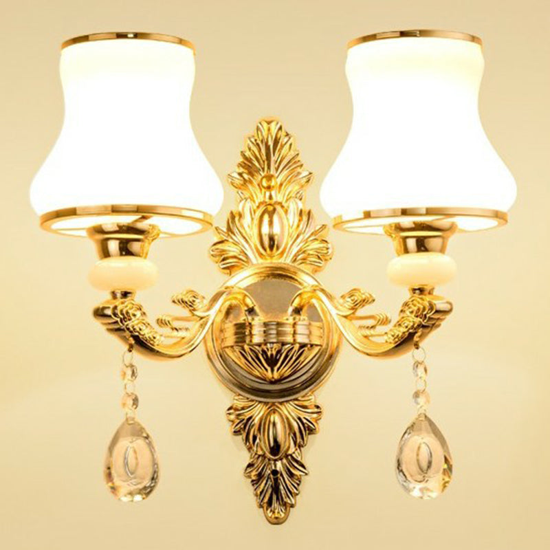 Gold two light sconce with rounded opal glass gourd shades