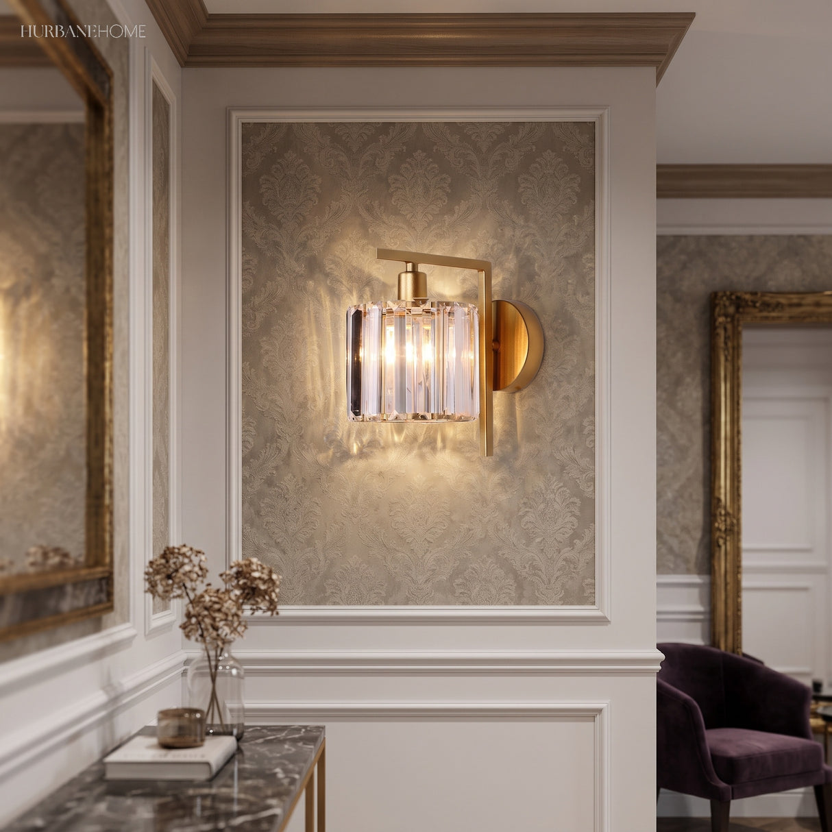 Crystal column sconce lit in a panelled hall beside a side table