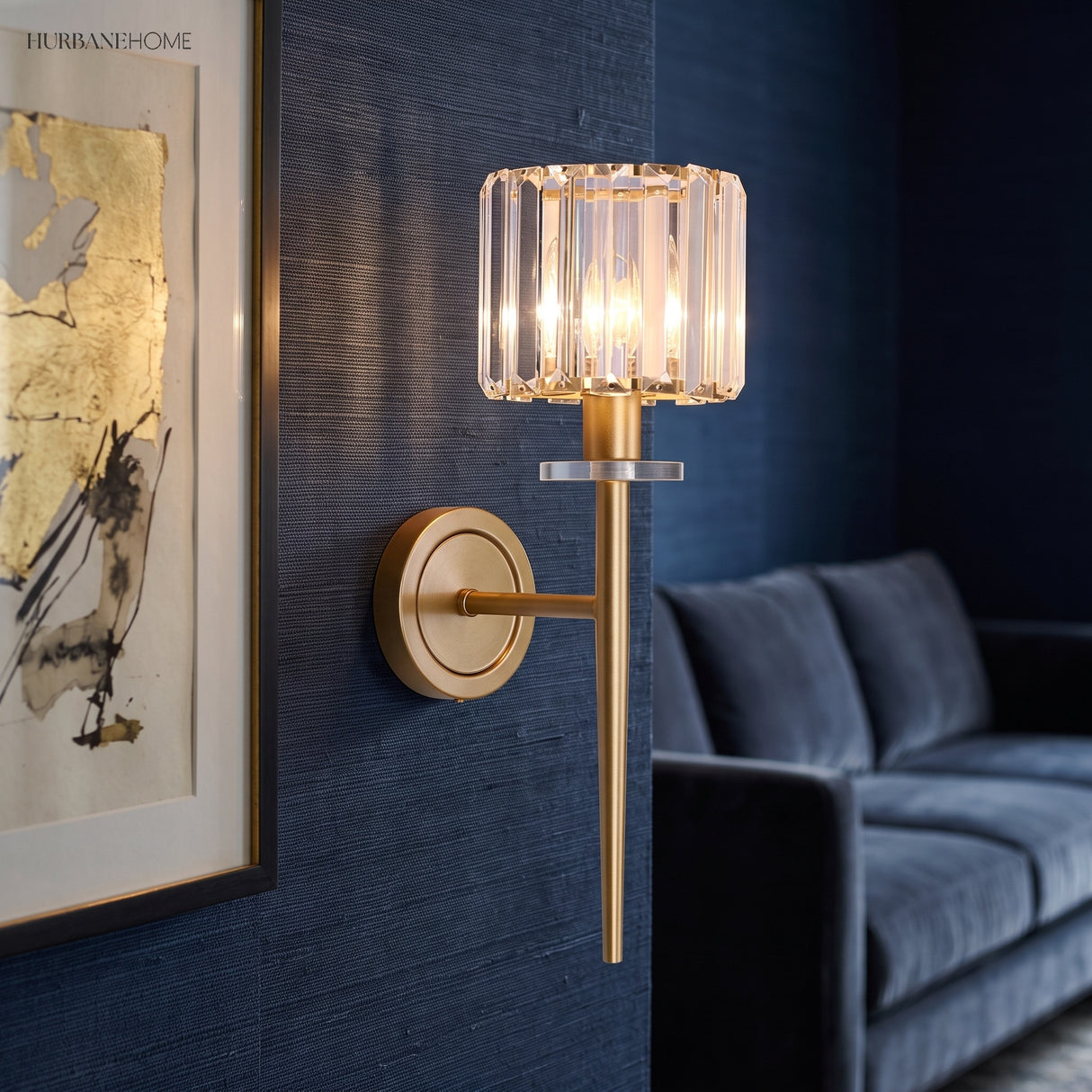 Crystal sconce on a blue wall beside a framed bird print