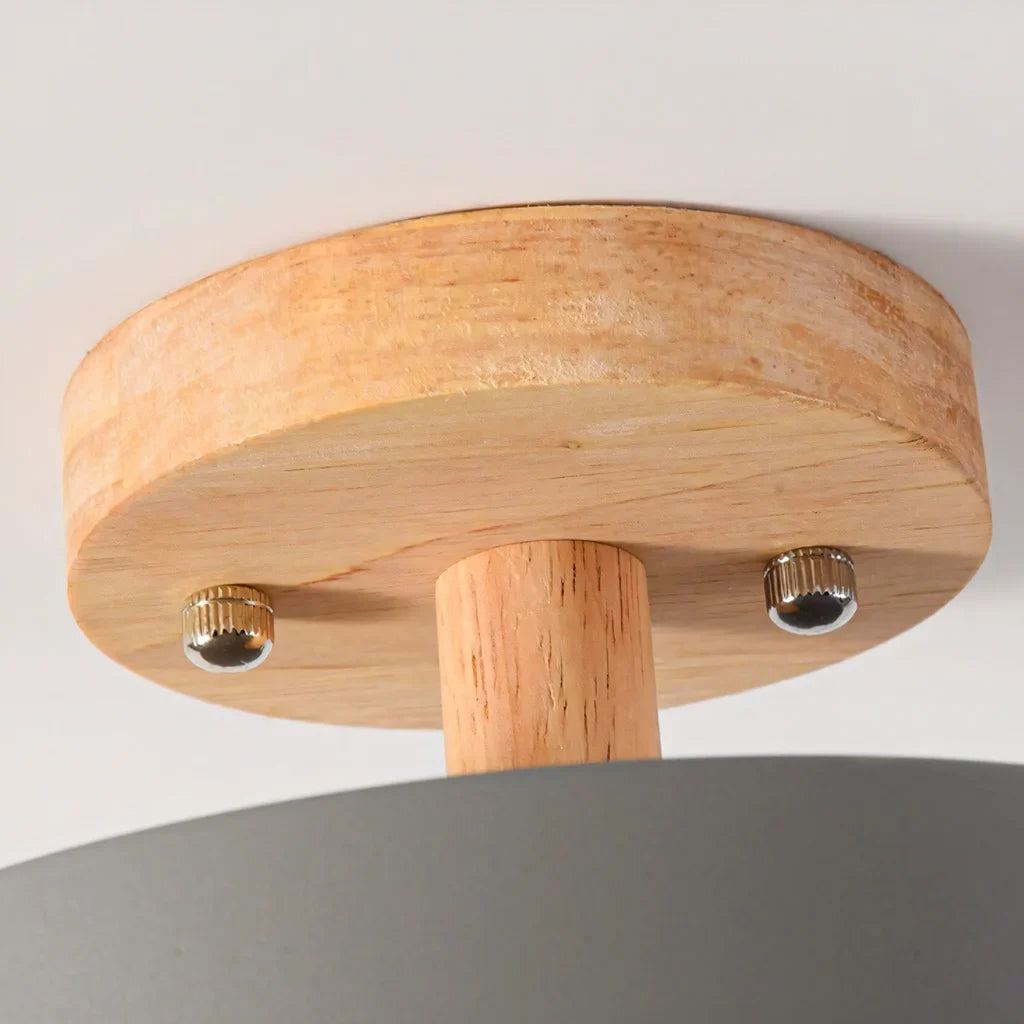 Close view of the wood mount and screws on the flush ceiling light