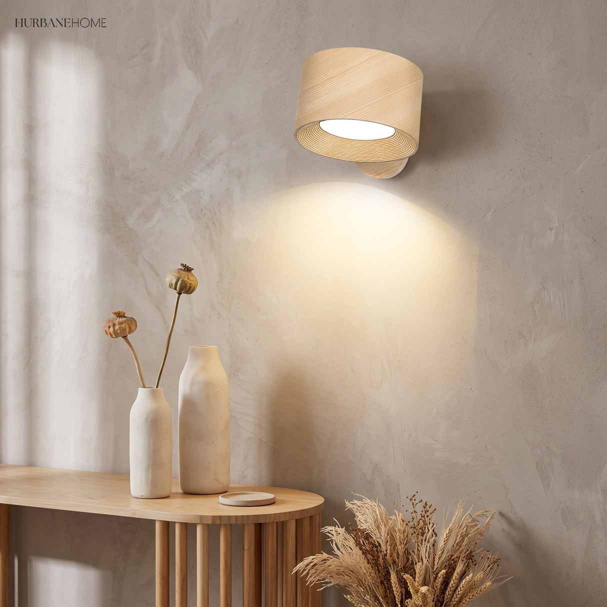 Wood dimmable wall sconce tilted down to spotlight a console with dried florals