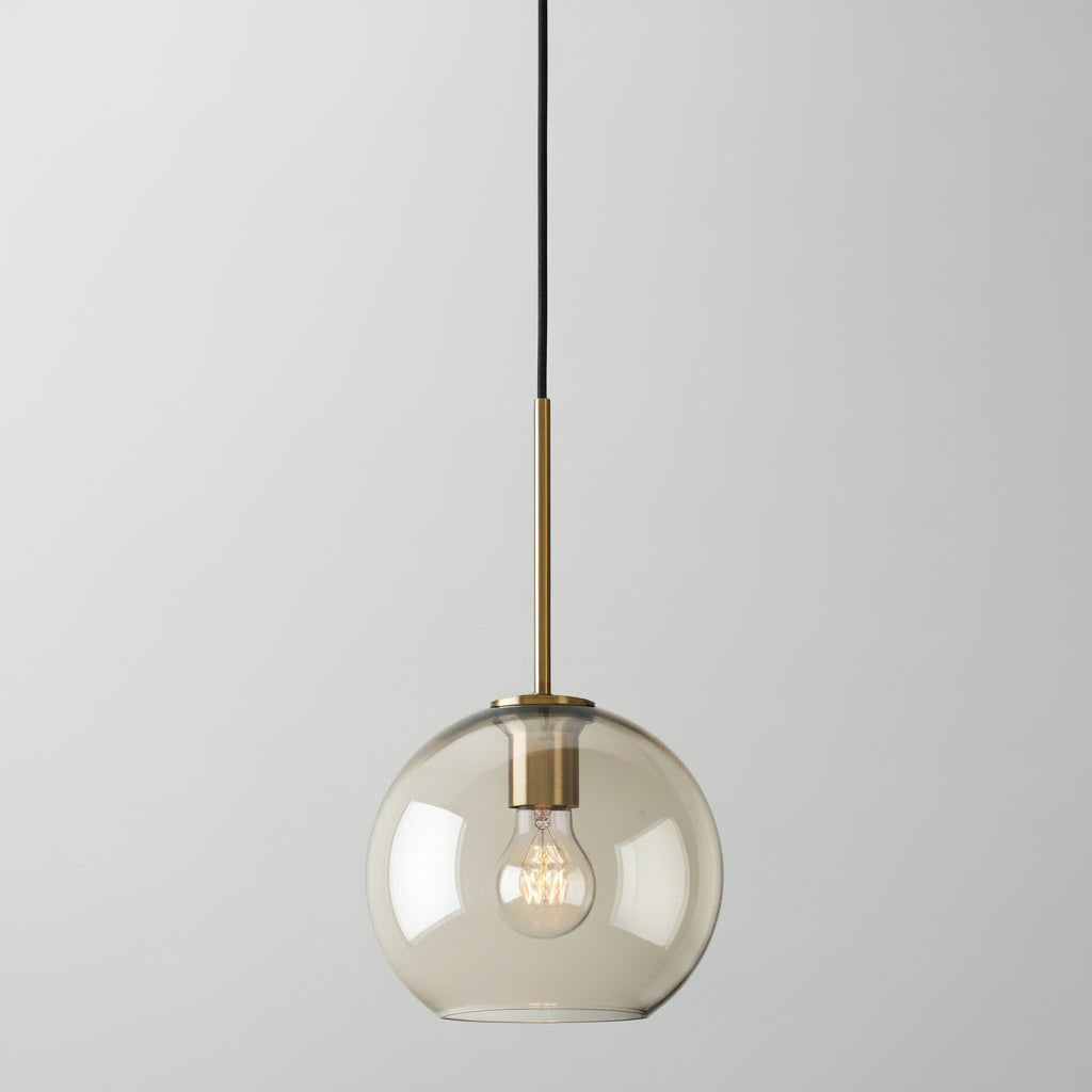 Studio shot of the small amber glass globe shade and brass cap