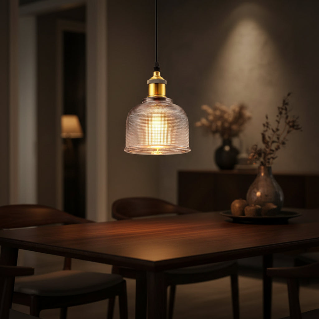 Clear ribbed glass pendant with warm light through the prisms