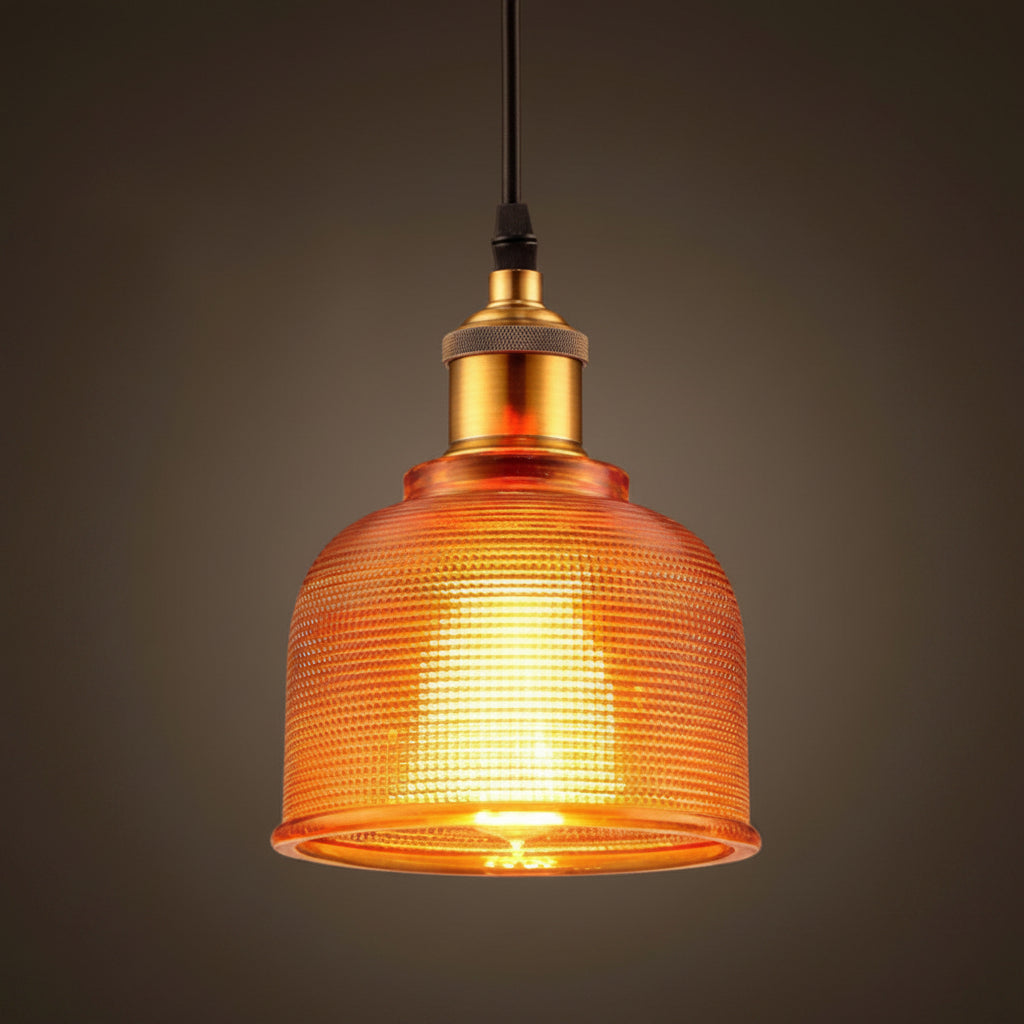 Orange ribbed glass bell pendant lit against a dark background