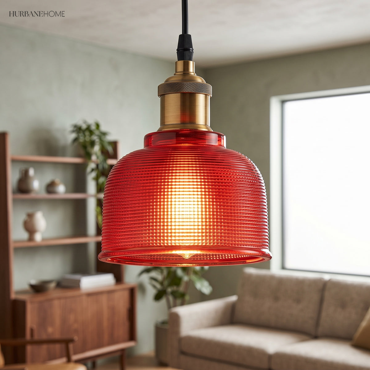 Red bell pendant beside a window in a living room