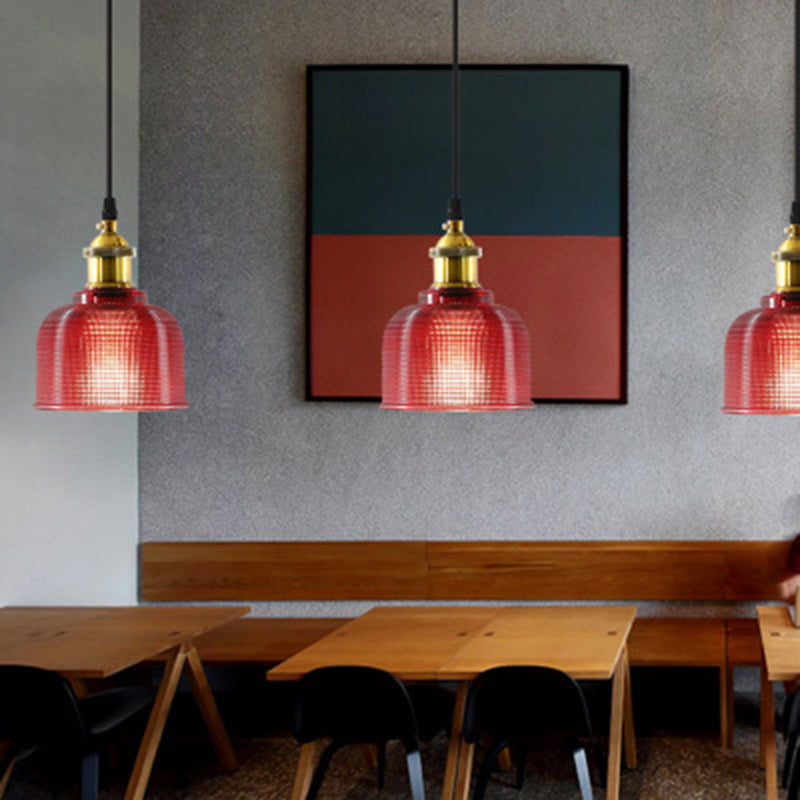 Three red ribbed glass pendants along a cafe banquette table