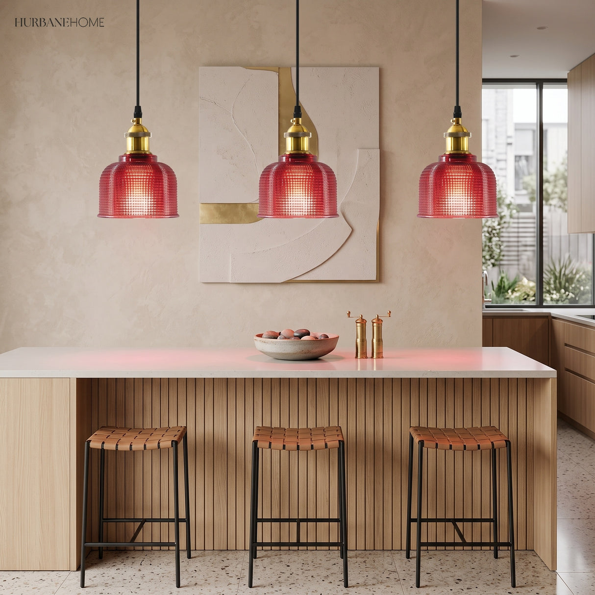 Three red ribbed glass pendants hanging over a kitchen island
