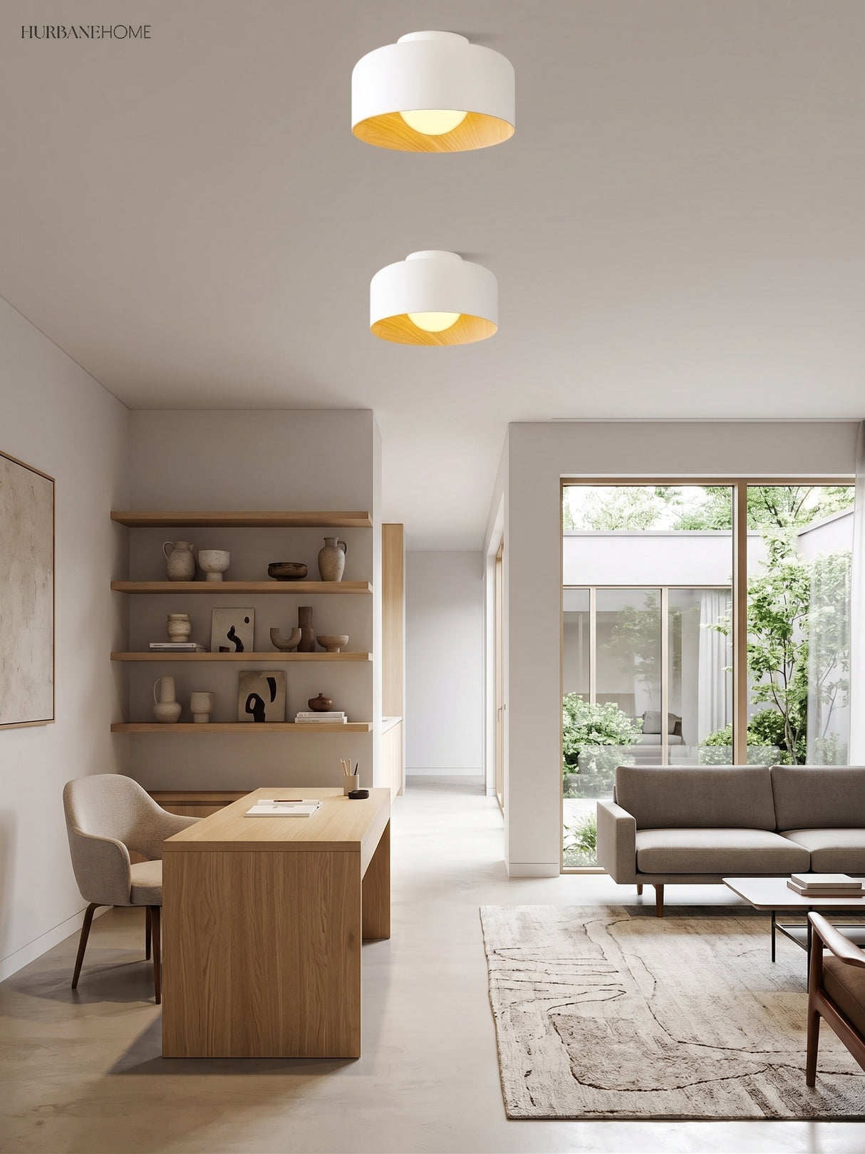 Two white drum ceiling lights above an oak dining table and open shelving
