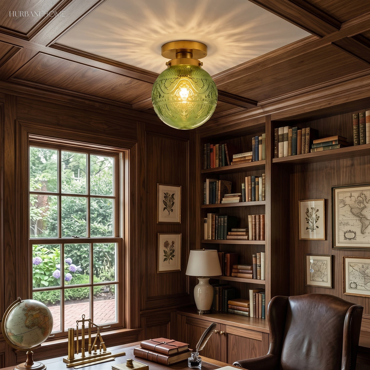 Green engraved glass globe ceiling light in a panelled wood study