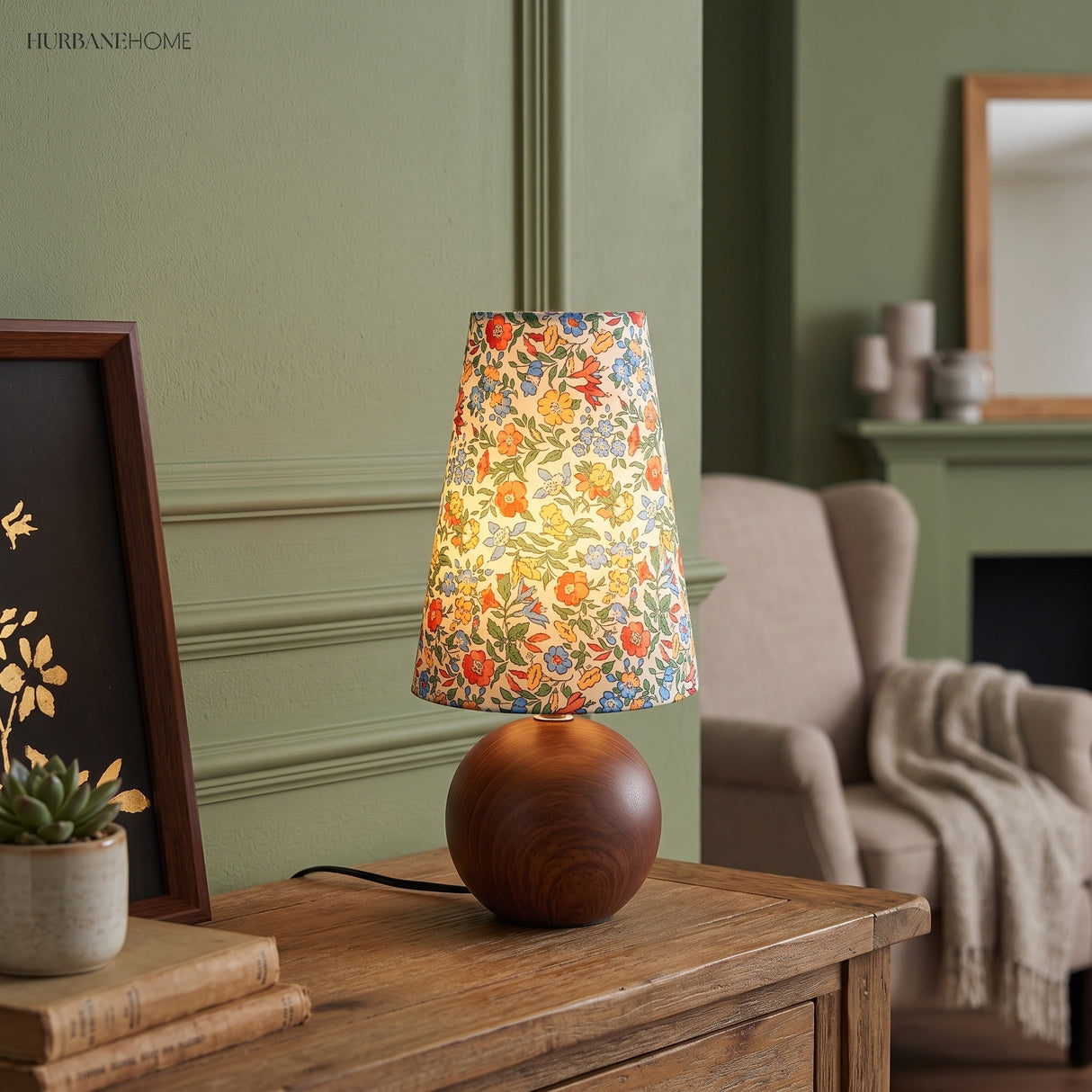 Floral table lamp beside a mirror on a console in a green living room