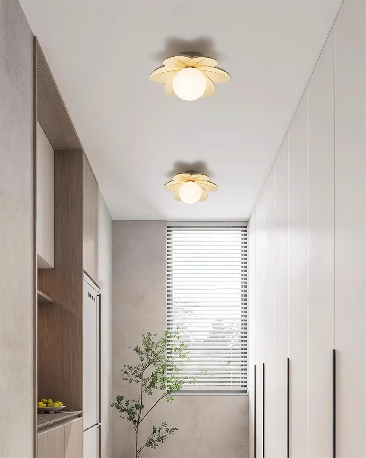 Flower ceiling lights running down a narrow hallway lined with tall plants