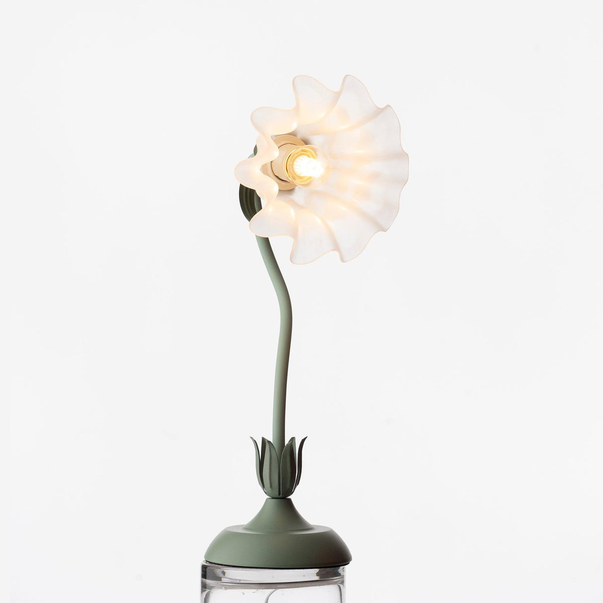 Studio view of the shade fanned flat, showing the bulb at its centre