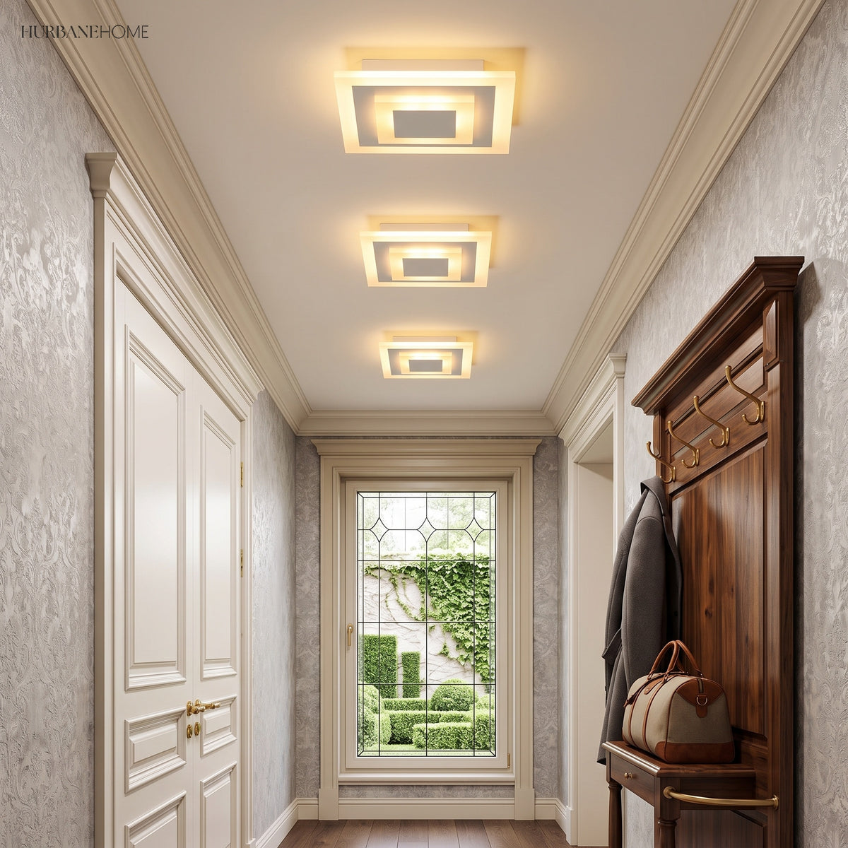 Three small square ceiling lights lining a paneled entry hallway