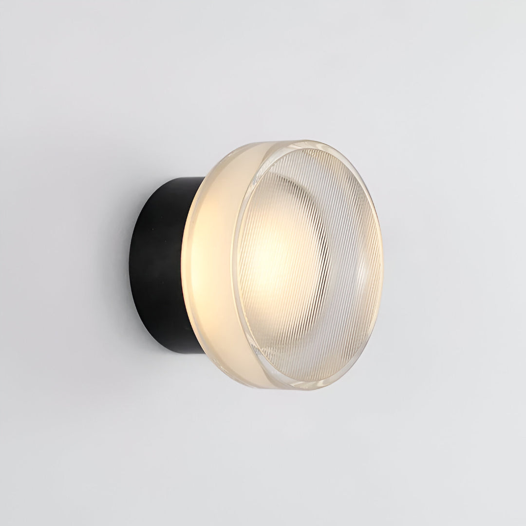 Two ribbed disc wall lights in a hallway with an arched opening
