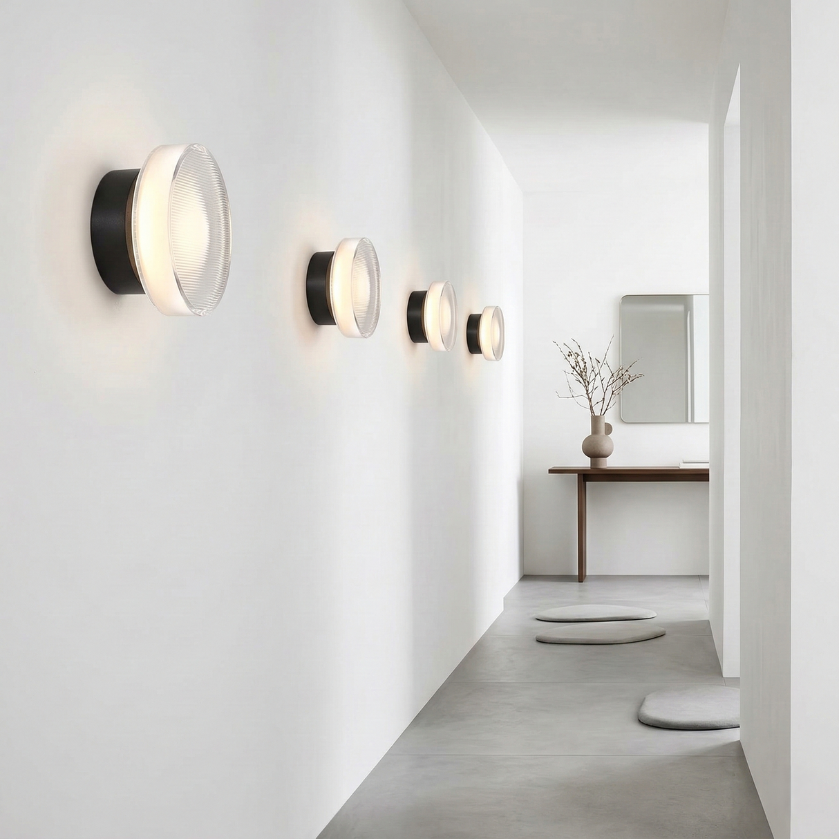 Gold ribbed wall light lit above a desk with a laptop and plant