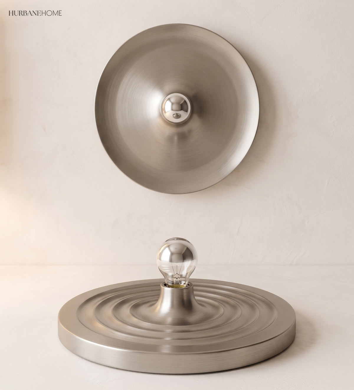 Silver ripple disc light with a small bulb at its centre