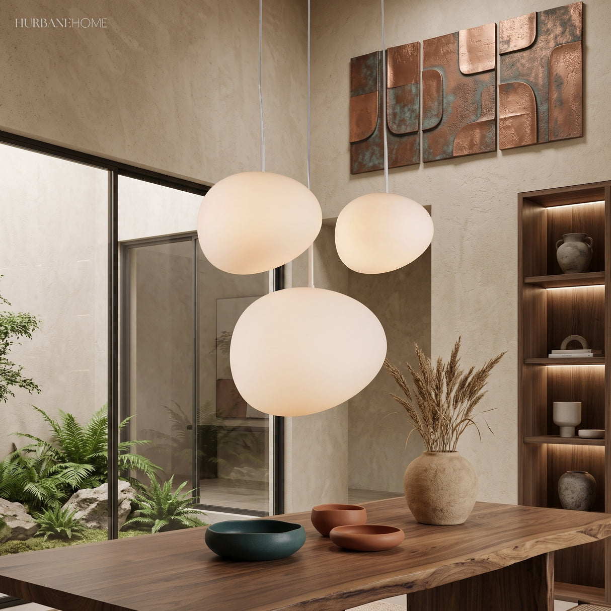 Three pebble pendants lit in a room of timber and green plants