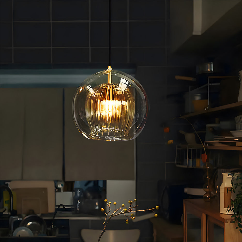 Glass globe pendant light with a brass top fitting