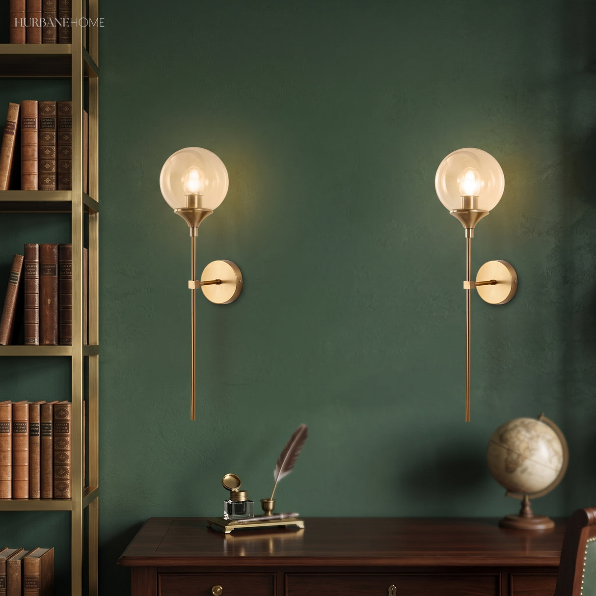 Pair of clear glass globe wall sconces on a green study wall by a bookshelf