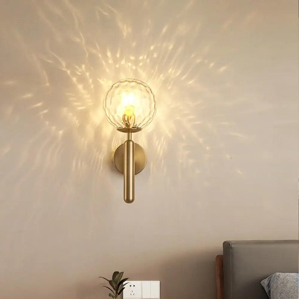 Ripple glass globe scattering points of light across a warm wall