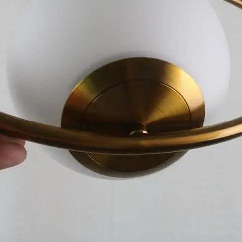 Close view of the brushed brass ceiling canopy and cable fitting