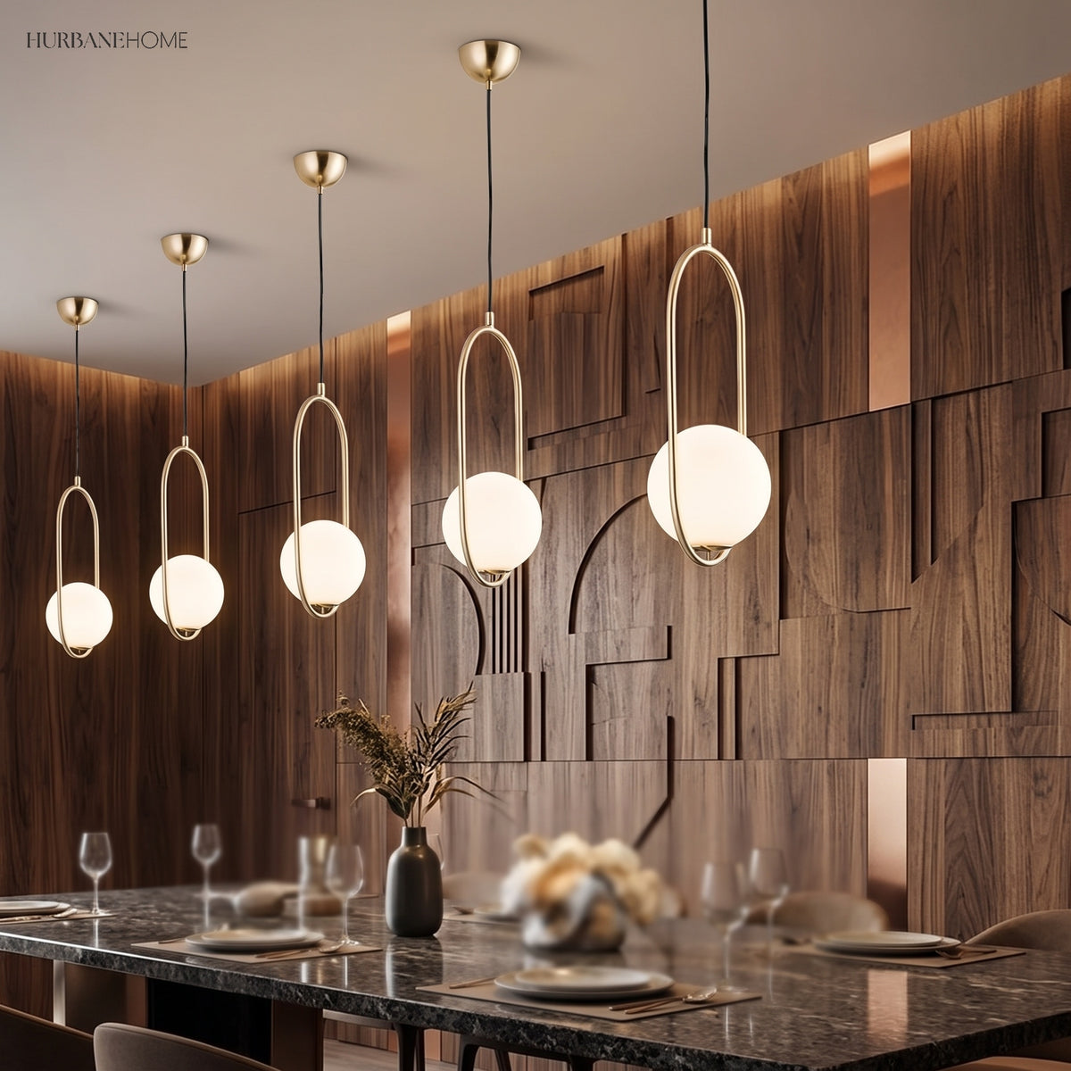 Gold globe pendants in a line above a marble dining table
