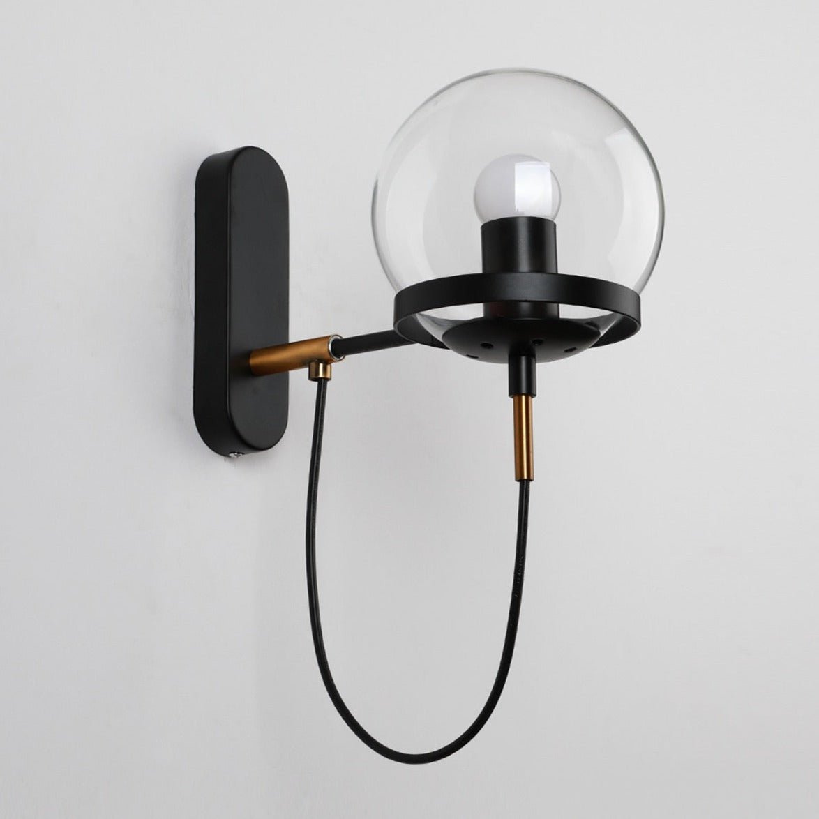 Black globe wall sconce shown unlit against a white background