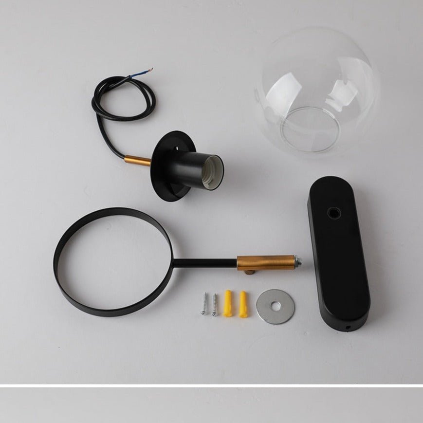 Black sconce parts laid out with the globe cord loop and fixings