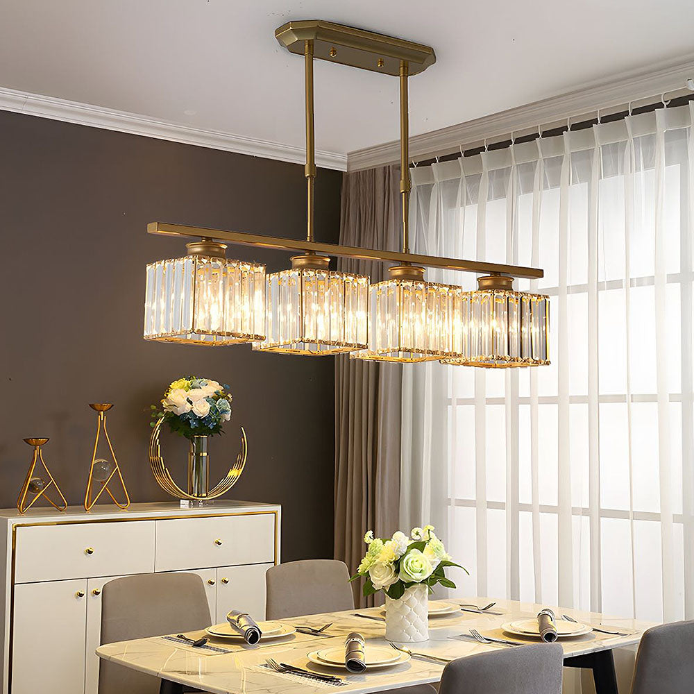 Gold four light island chandelier above a marble dining table with flowers