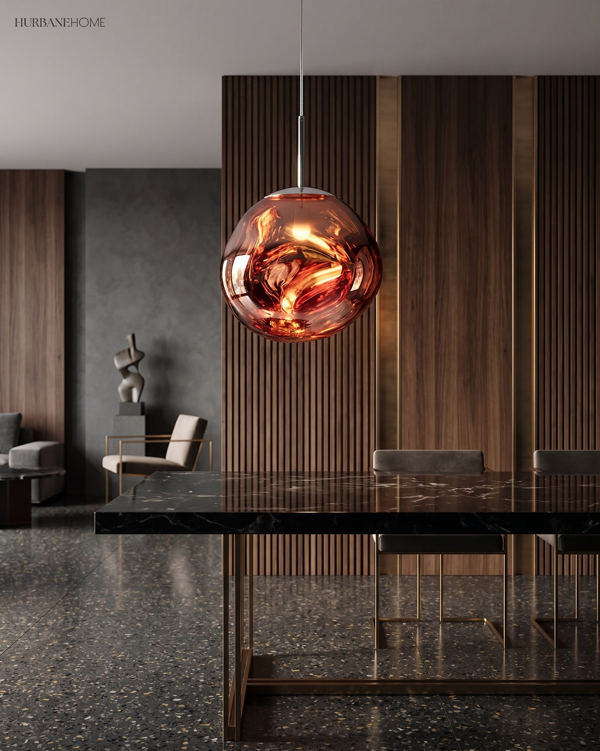 Rose gold molten pendant light hanging low over a dark stone dining table