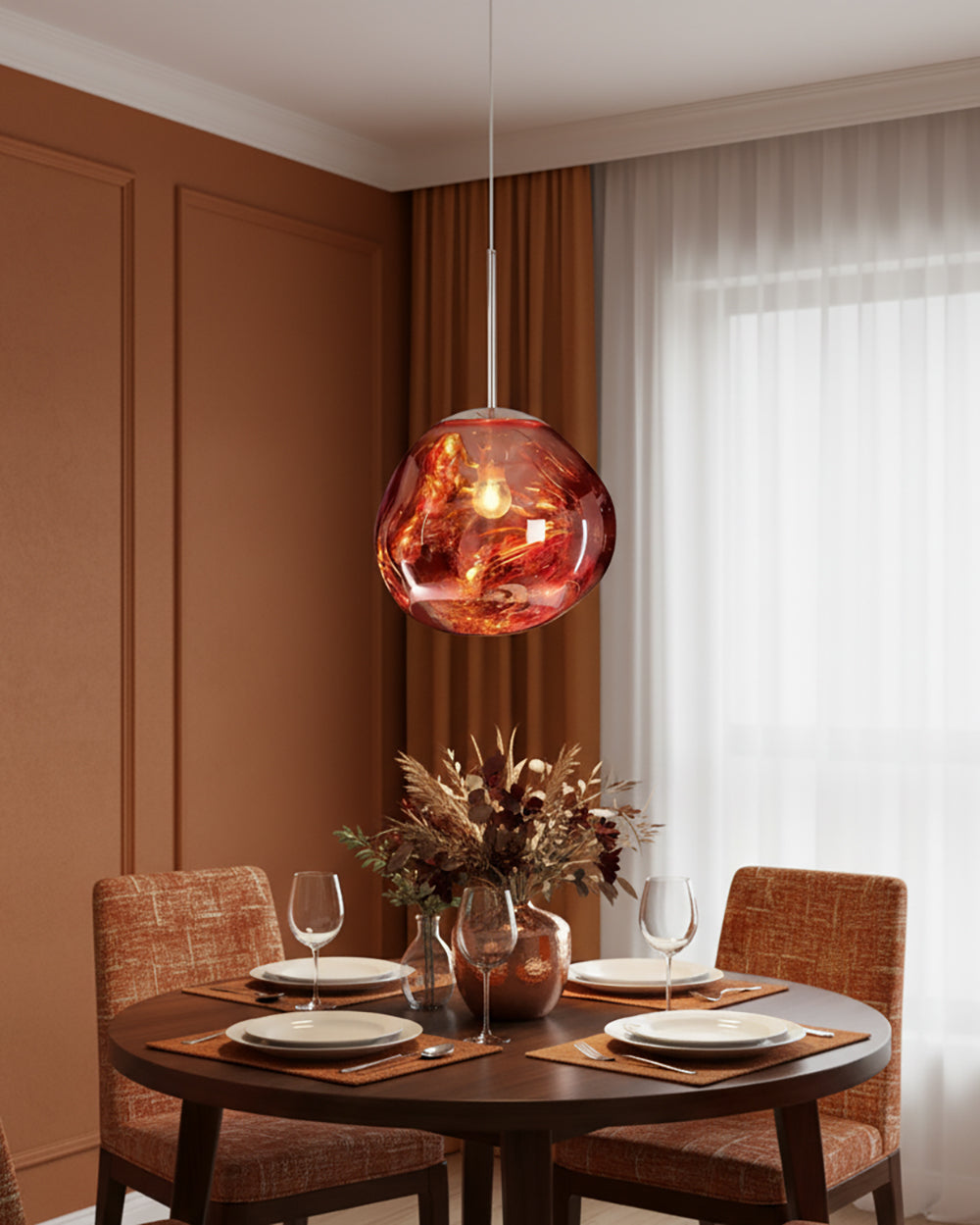 Copper pendant over a round table set for two in a panelled terracotta room