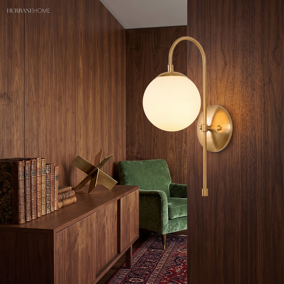 Gold globe sconce lit on a walnut panelled wall above a sideboard