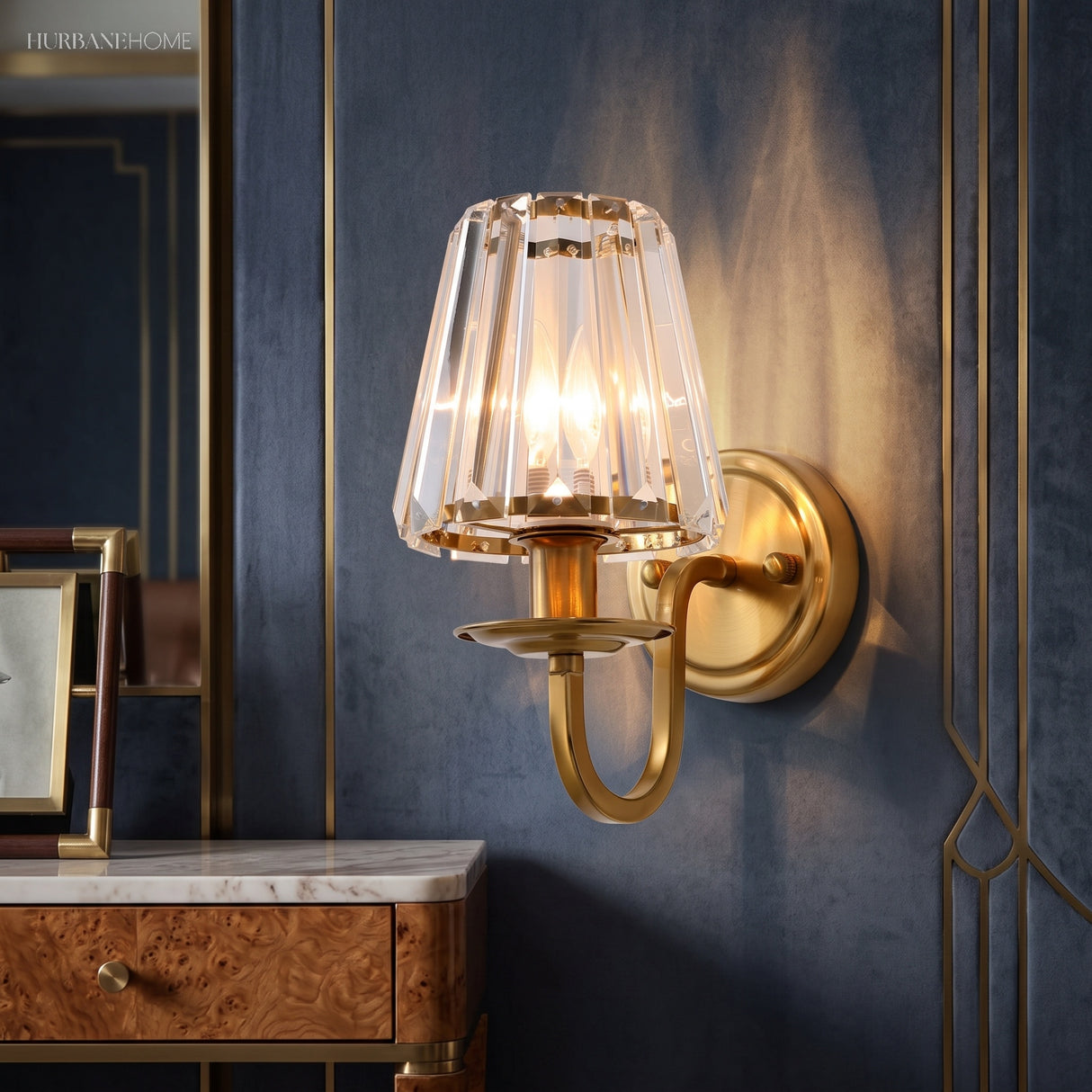 Crystal cone sconce on a navy wall beside a burl wood dresser