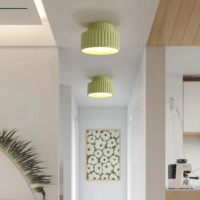 Green fluted semi flush mount ceiling light on a plain studio background