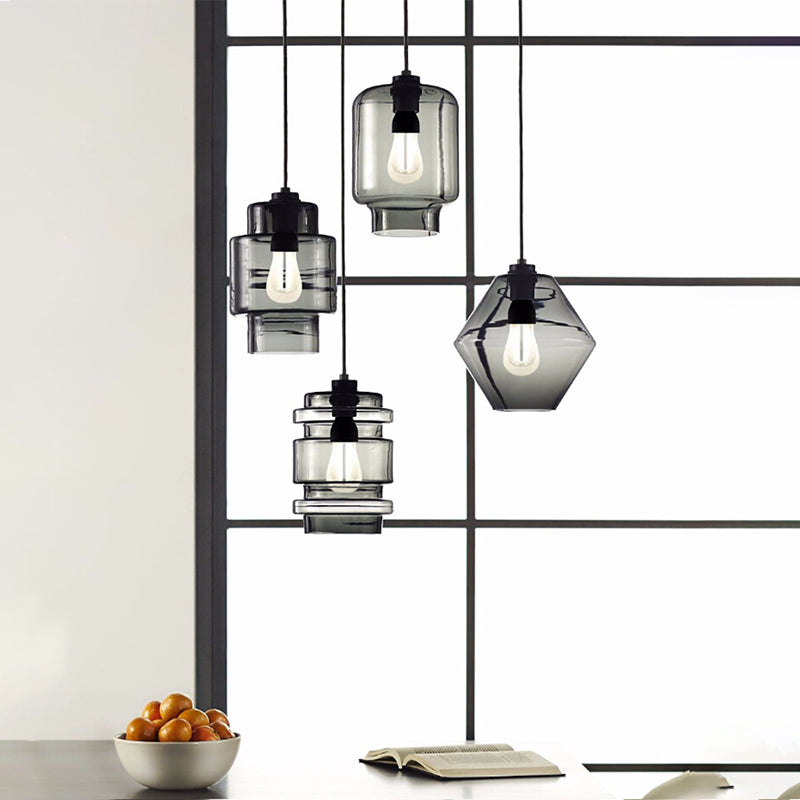 Clear and smoke pendants in mixed shapes hung in a window frame