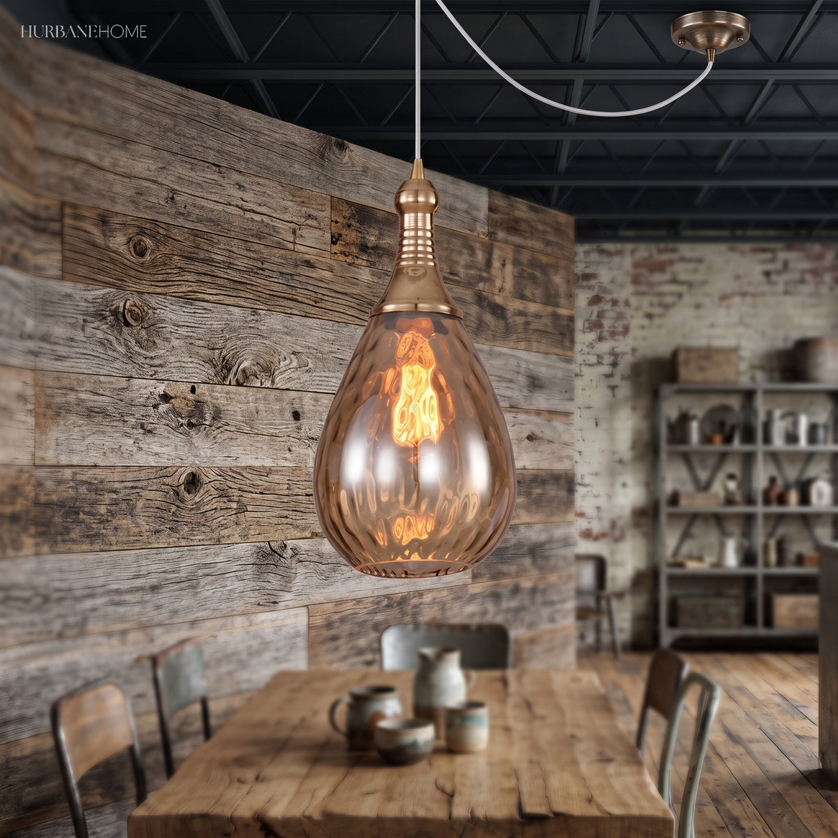 Teardrop pendant lit against a reclaimed timber wall above a table