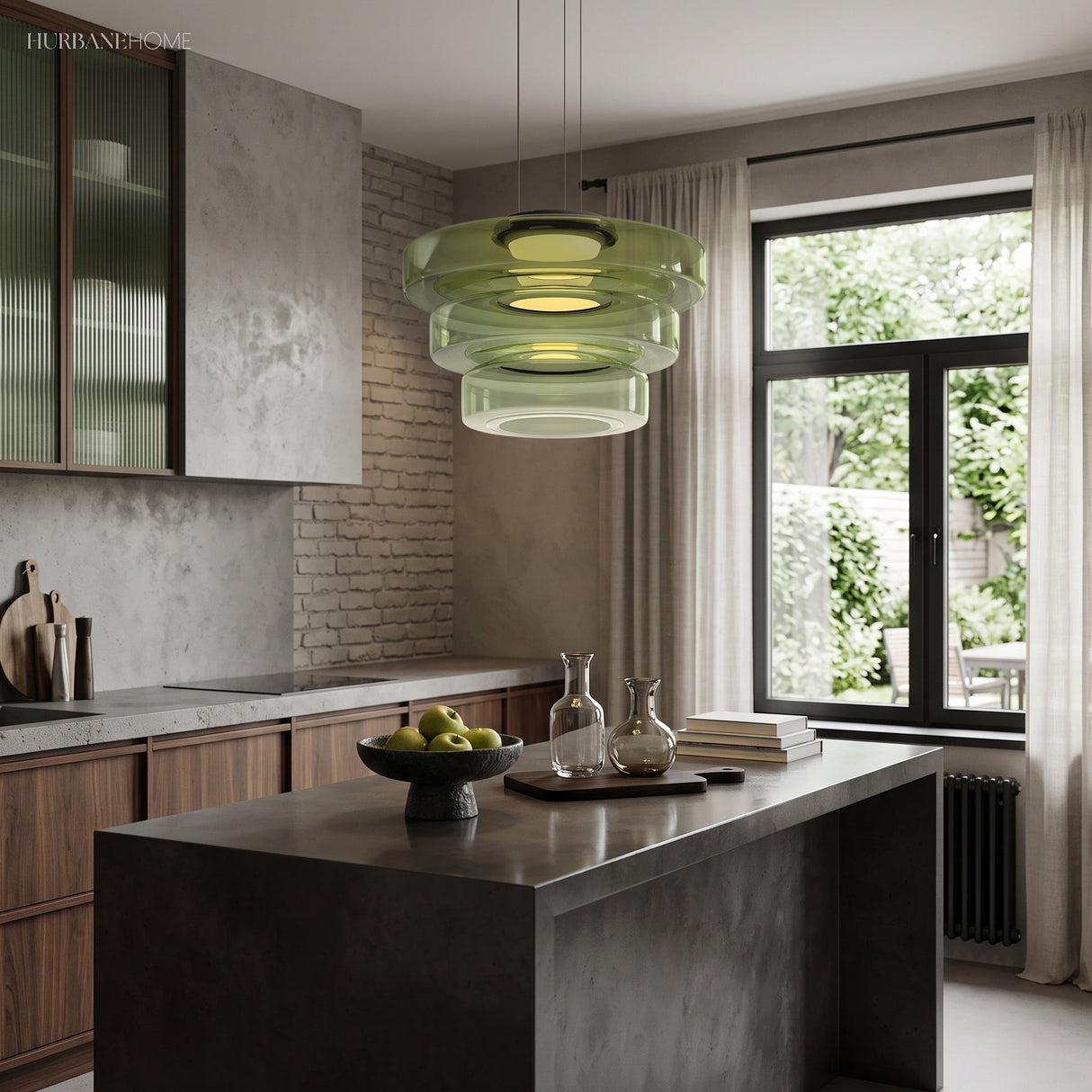 Green glass disc pendant light over a kitchen island beside a window