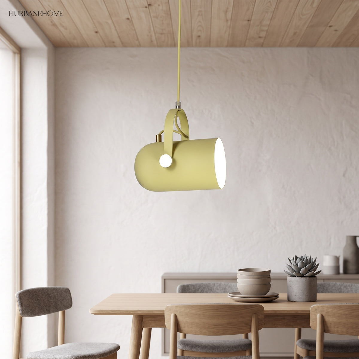 Yellow angled pendant lit above a wooden dining table and chairs