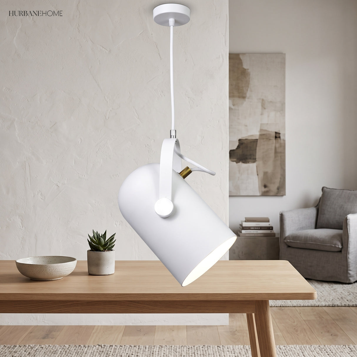 White angled pendant lit above a light wooden dining table