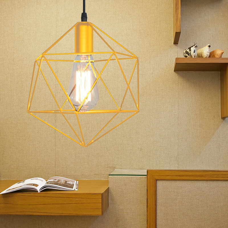 Gold cage pendant lit above a book on a pale timber ledge