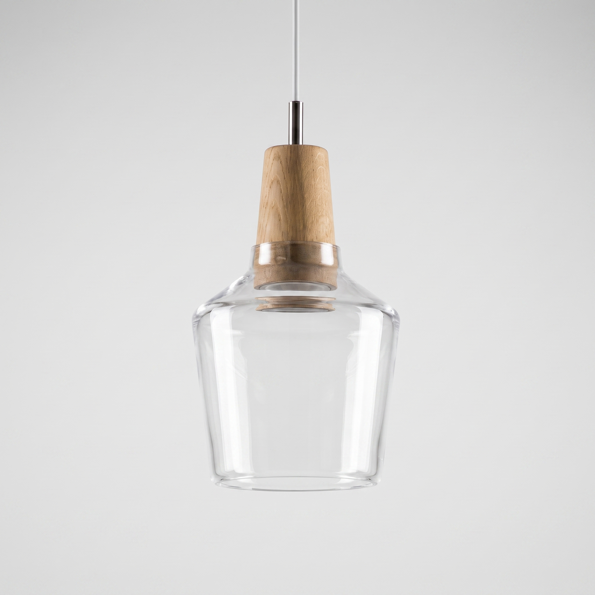 Tall clear glass bell shade with a natural wood top on a cable