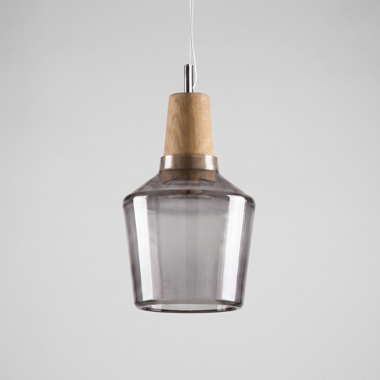 Tall grey smoke glass bell shade with a pale wood top