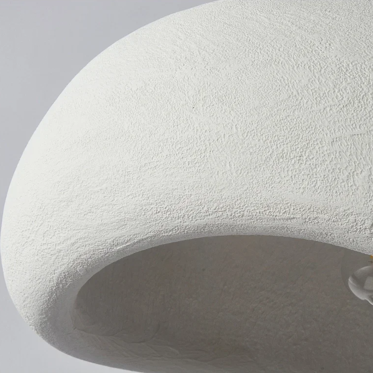 Close view of the smooth white shade surface and cut rim